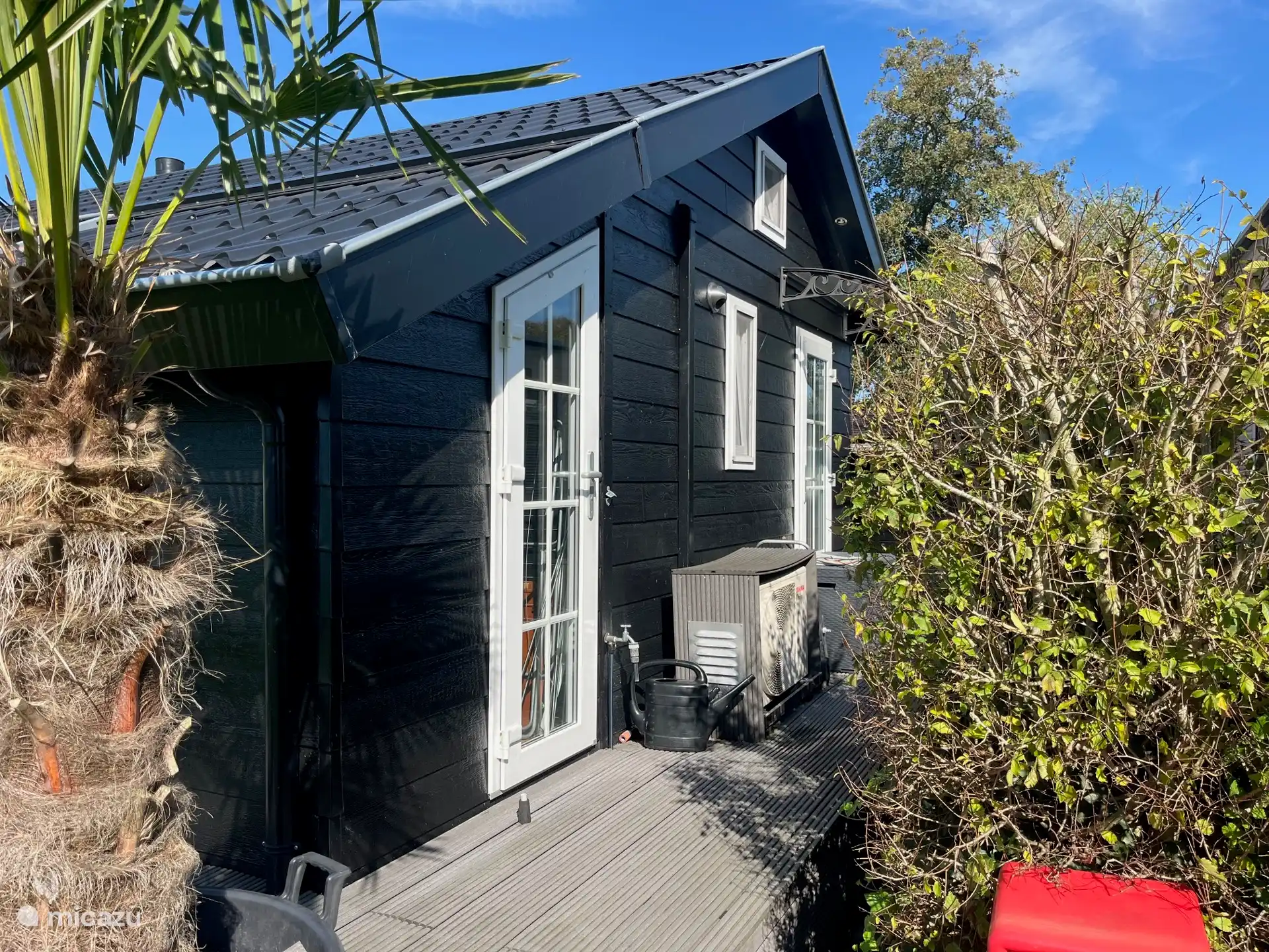 Back with visible window of upper sleeper, air conditioning and outside tap