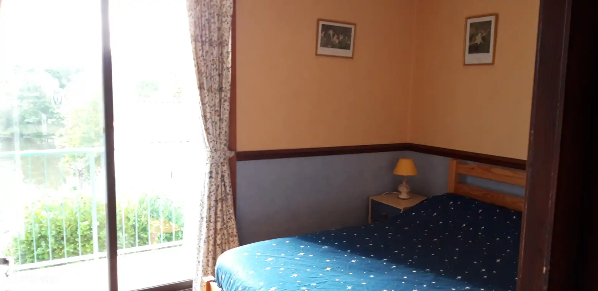 The master bedroom with ledge wall and sliding doors to the lovely balcony where you have a beautiful view over the lake.