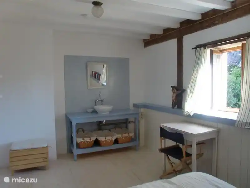 Same Schlafzimmer vom Bett gesehen, Waschbecken vorhanden. Kleine Schreibtisch, wo Sie ungestört schriftlich sitzen kann, mit Blick auf den Garten.