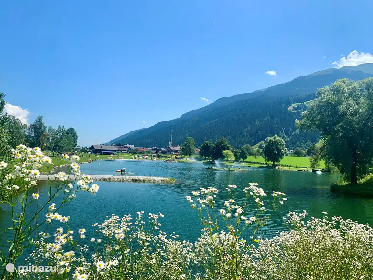 The natural swimming lake in Hollersbach, located right next to the valley station of the gondola. For the children there is plenty of fun, a beach with a pirate ship, a cable car over the water, slides.