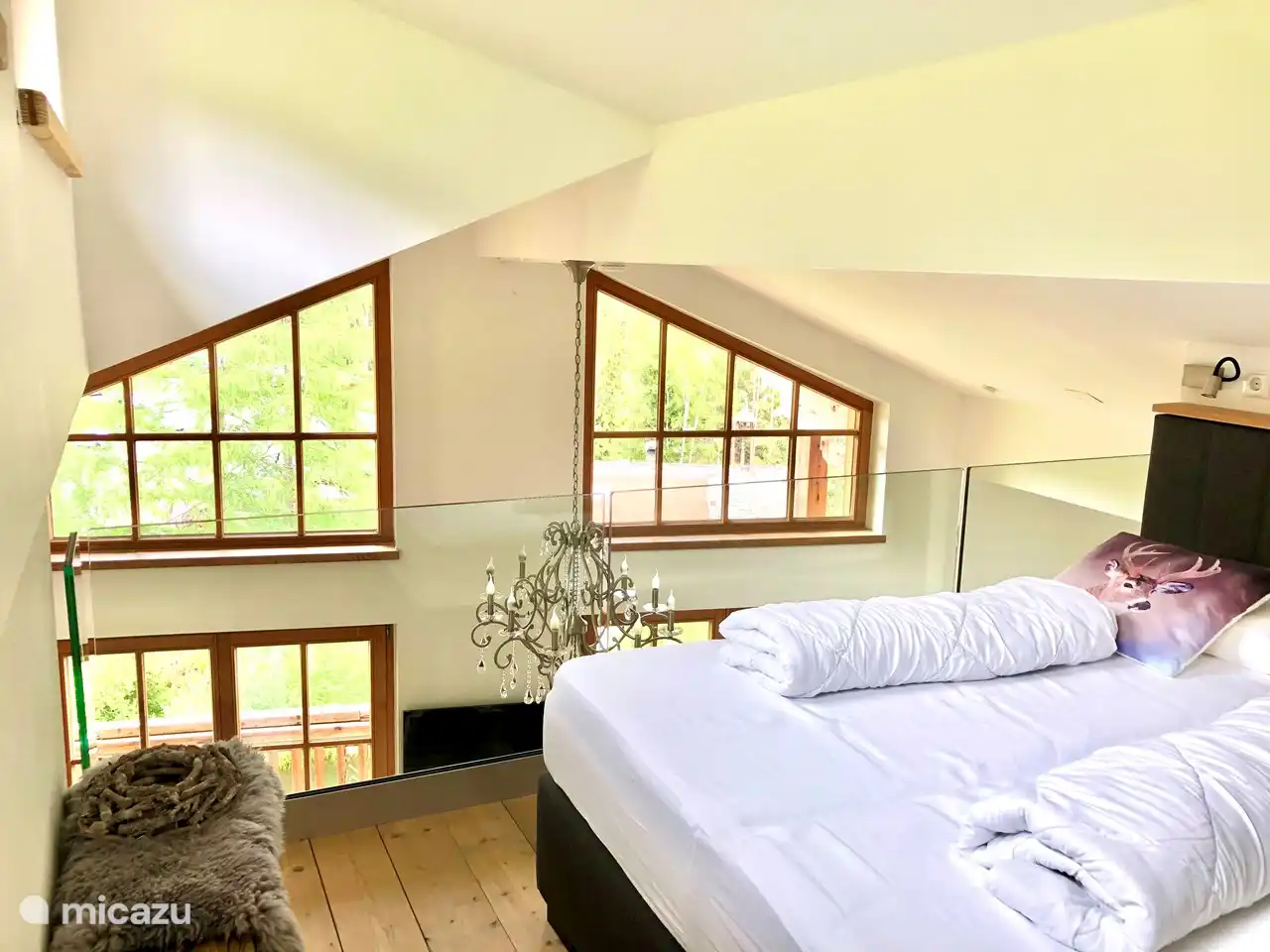 Master bed on mezzanine with a view of the mountains