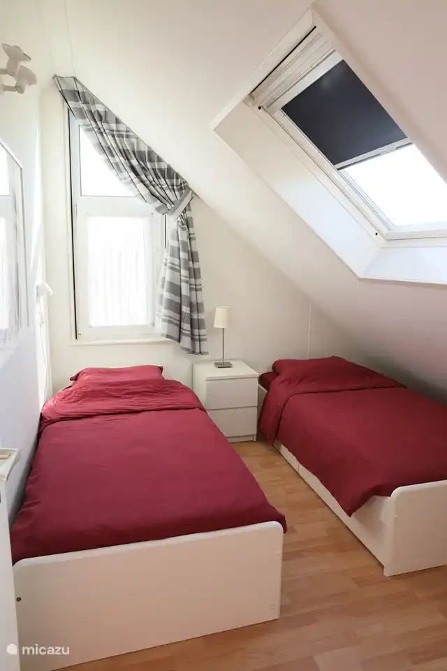 De slaapkamer met twee eenpersoonsbedden, onderladen, kledingrek met hangertjes en wastafel. Bij aankomst zijn de bedden al voor u opgemaakt!