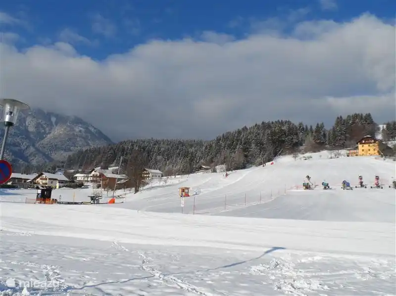 The baby lift, ski lift and piste