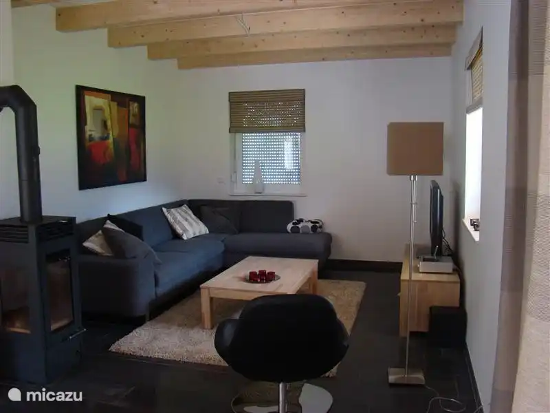 Living room with fireplace and television with NL channels via cable.