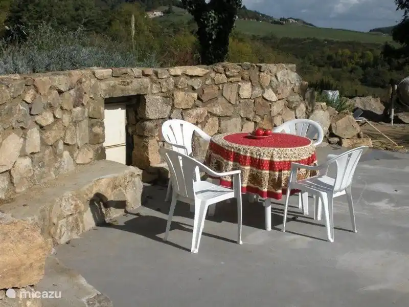 Private terrace opposite the house, which is separate from the pool area.