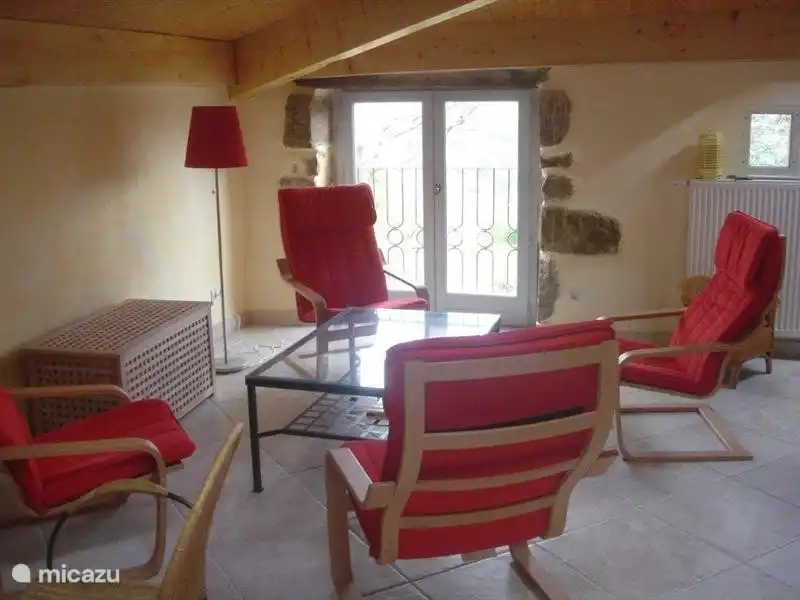 Lounge on the 1st floor with 4 chairs, coffee table, sofa and games area (table and chairs), TV present, but is not in the picture.