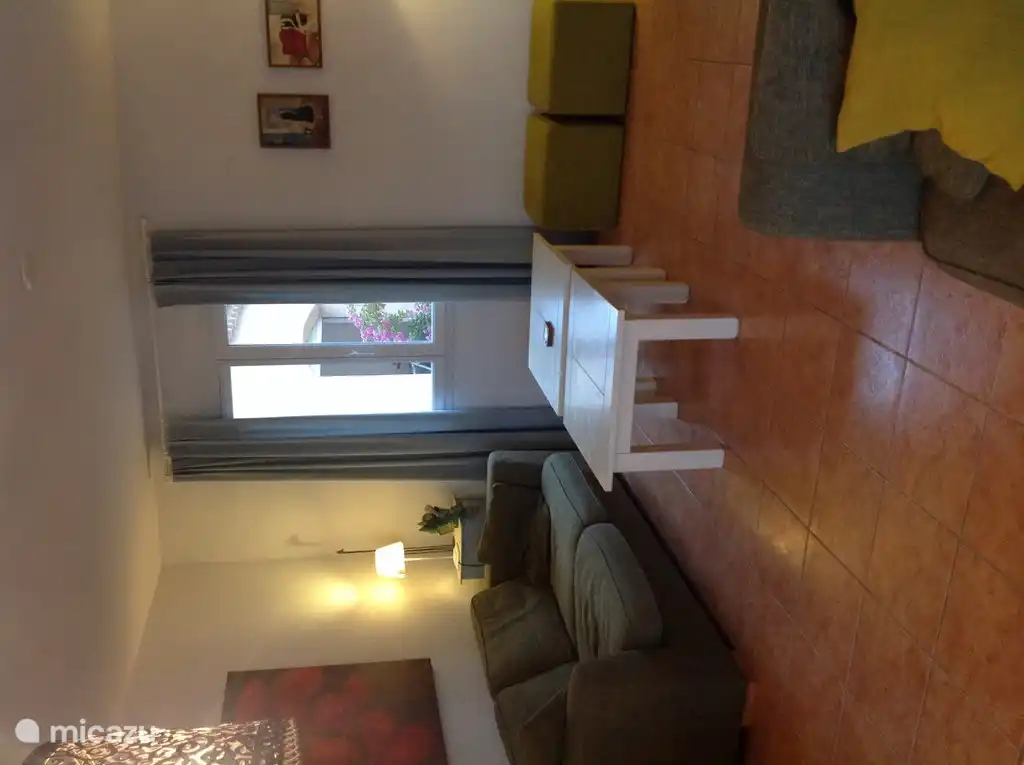 Interior, living room with sofa and 2 stools, 2 tables for tv room.