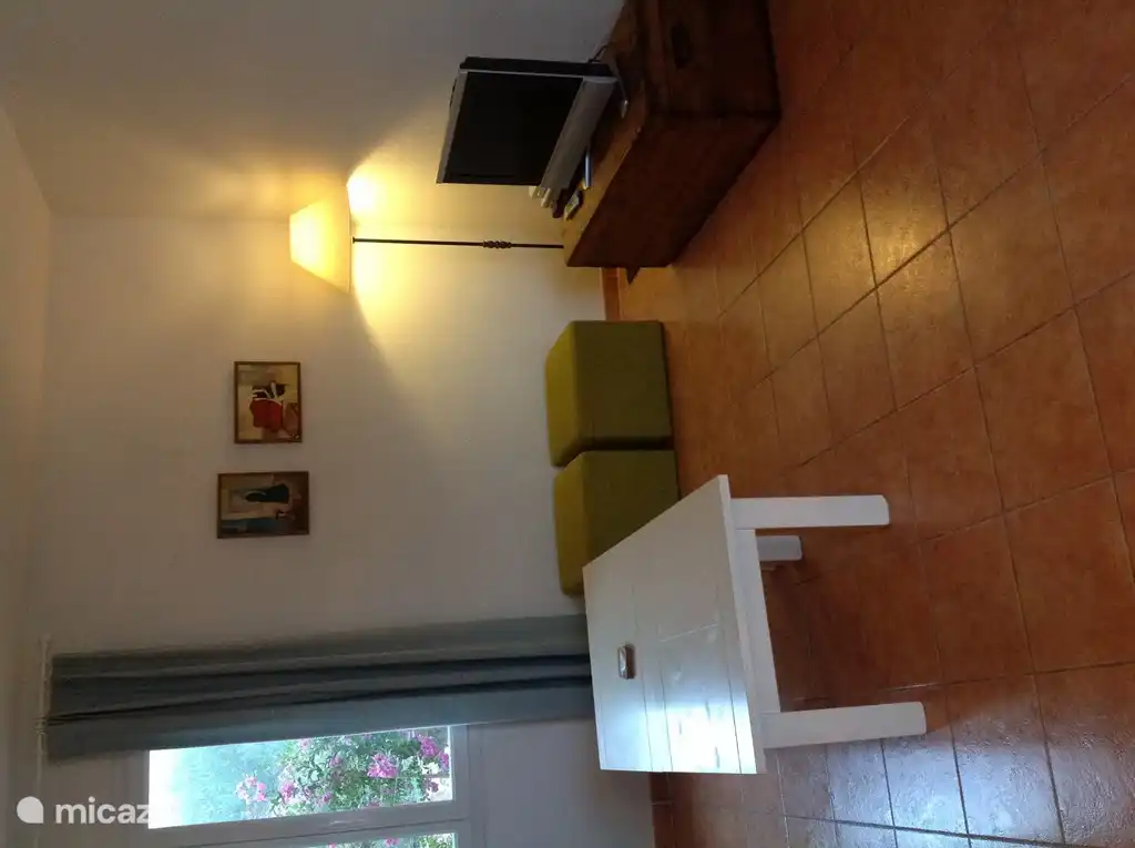 TV stands on a beautiful wooden blanket chest. Stereo and DVD present. DVDs and books, etc., see the sideboard on the other side of the living room.