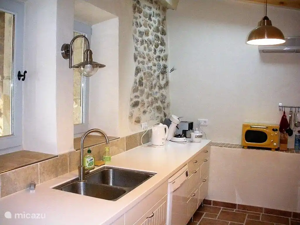 Kitchen with 2 windows that give views on pasture; the front door enters into the kitchen
