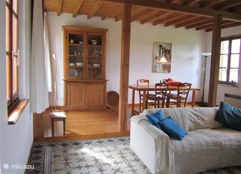 Dining area in living room with natural light and garden views