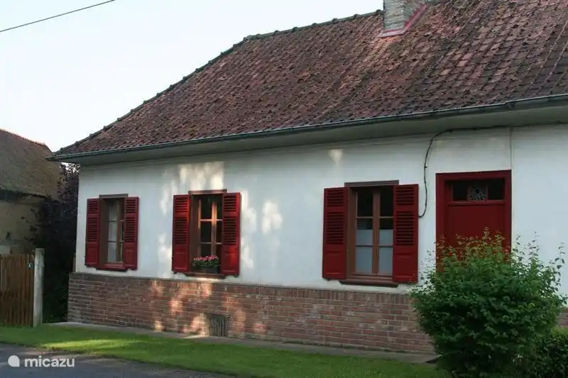 Front of Les maisons de Pompel with entrance door and gate for additional access to garden and backside of the house.