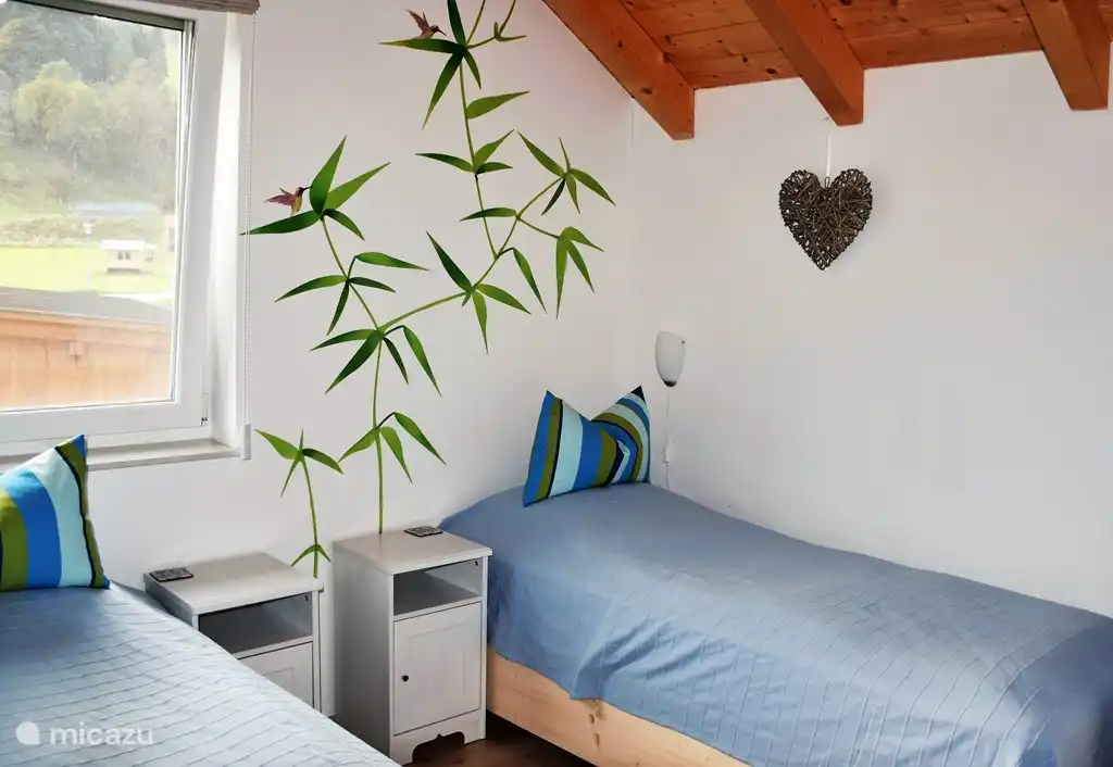 Children's bedroom with two beds and wardrobe. Beds can be pushed together.