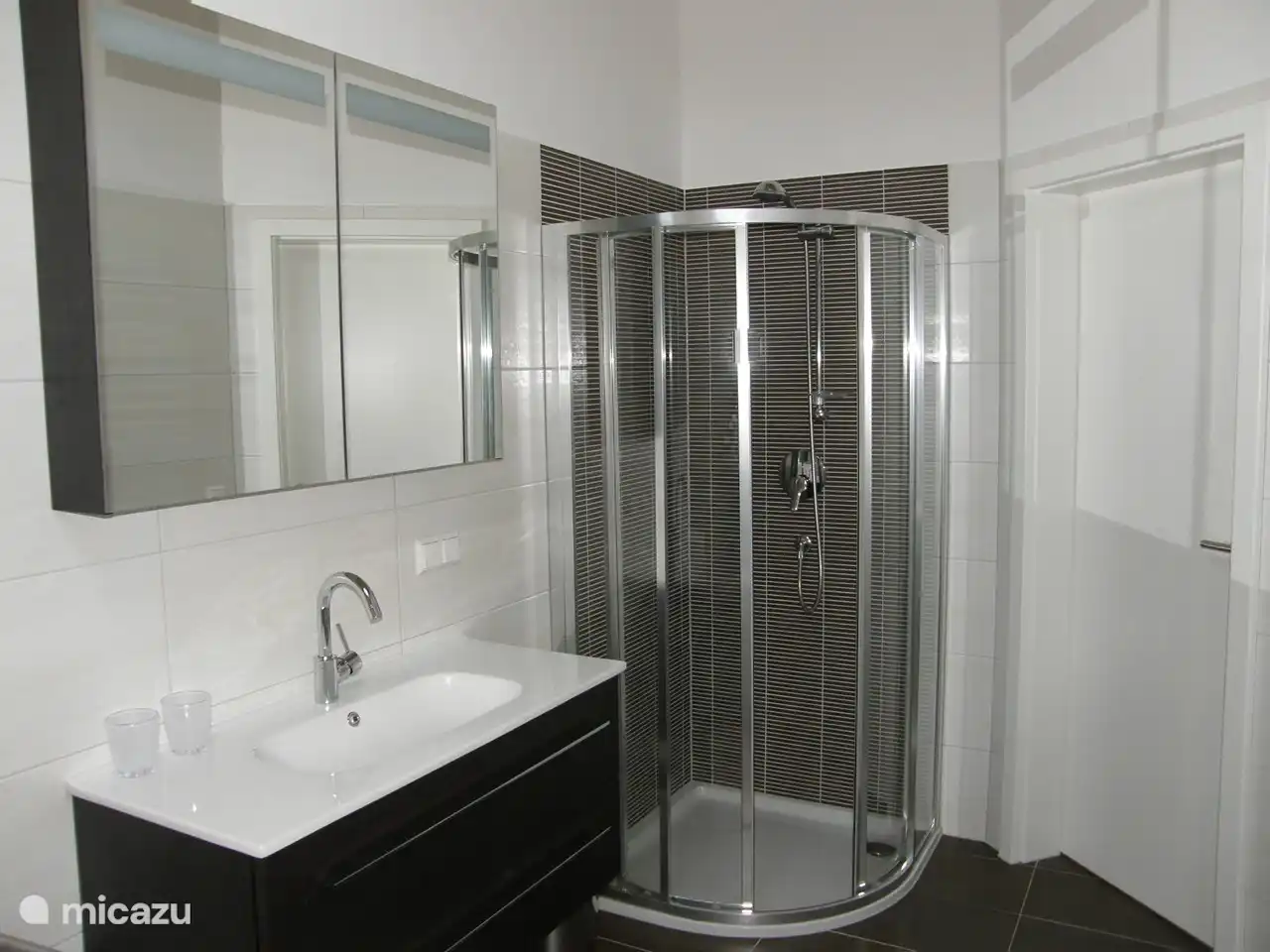 Bathroom with shower, sink
