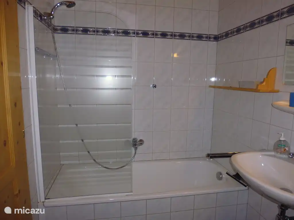 Erdgeschoss Badezimmer mit Bad / Dusche, Waschbecken und Toilette.
