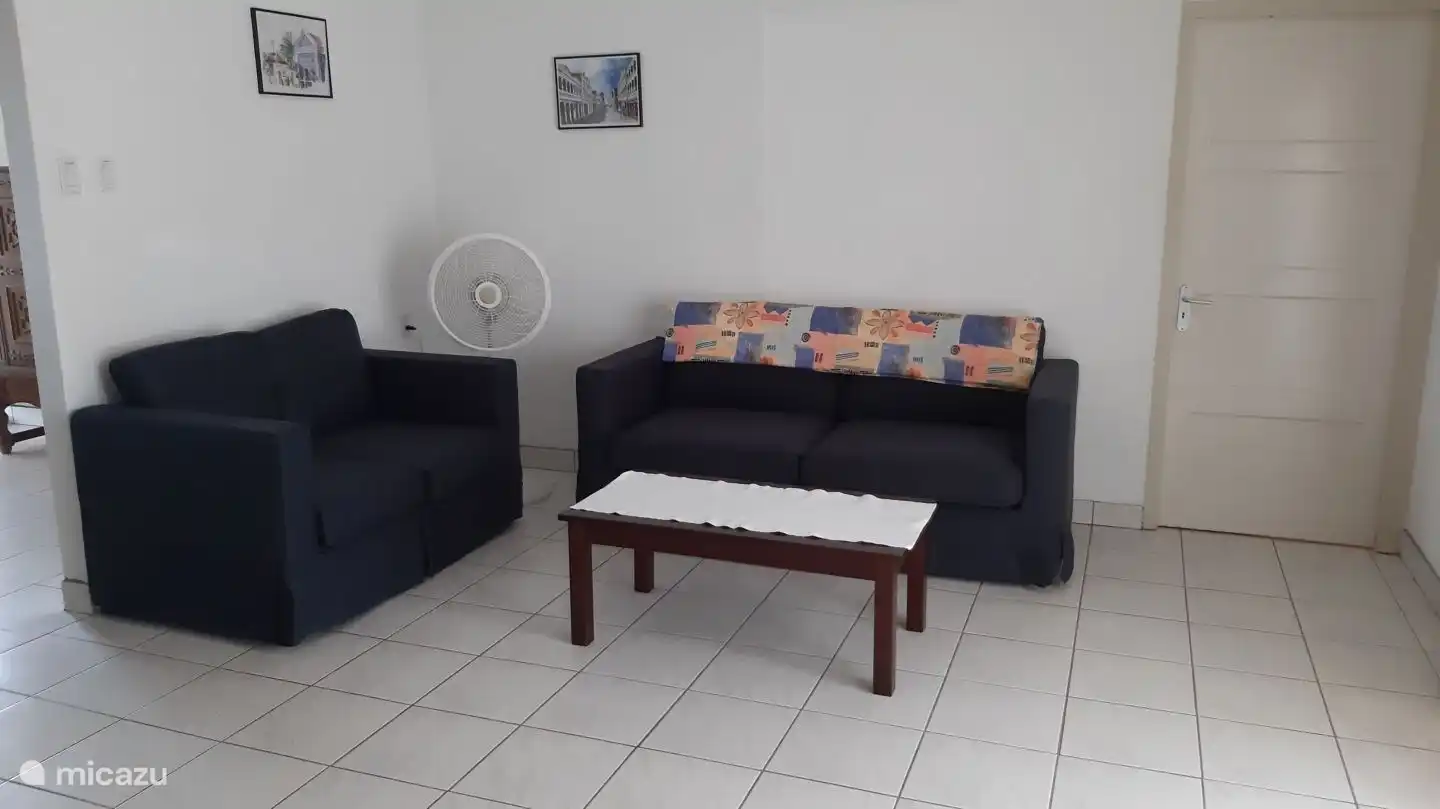 Our living room with three and two seater sofas and an armchair. 