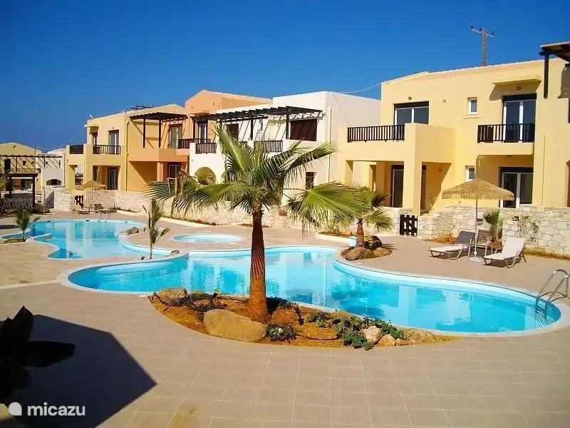 The house adjacent to the pools. It's three in overlapping pools and a paddling pool. Along the pools are sunbeds and umbrellas. Also, there are outside of showers. Around the pool and the house is a beautifully landscaped garden.