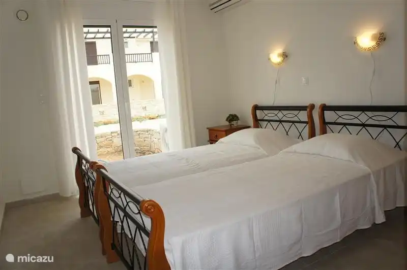 The spacious bedroom has two single beds (90X200), air conditioning and a large wardrobe. There are also doors to the terrace overlooking the pool and the sea.