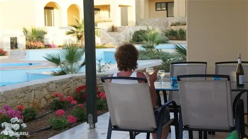 From the private terrace has sea view. The pools are two steps down, the access is closed by a low fence. There is a large dining table with four chairs. Sun beds and chairs are also in the pool area.