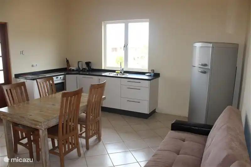 An open kitchen with microwave and dishwasher.