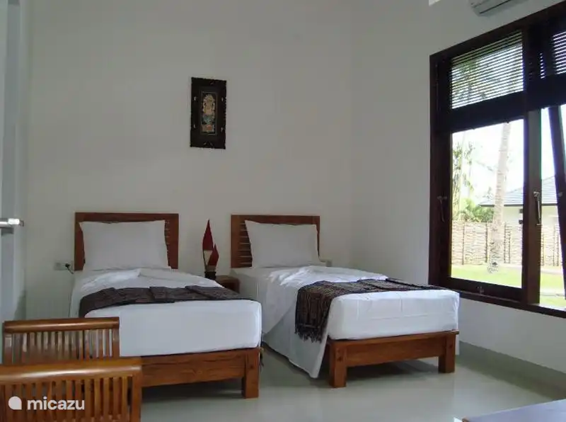 Slaapkamer 2 met kledingkast en koffertafel met aangrenzende badkamer.