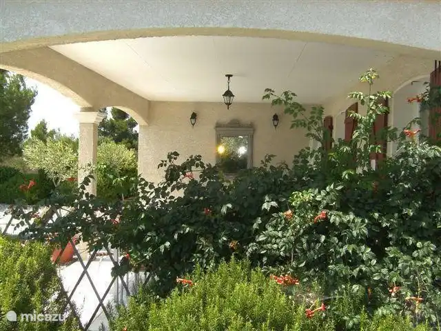 The covered terrace as seen from the side and front yard.