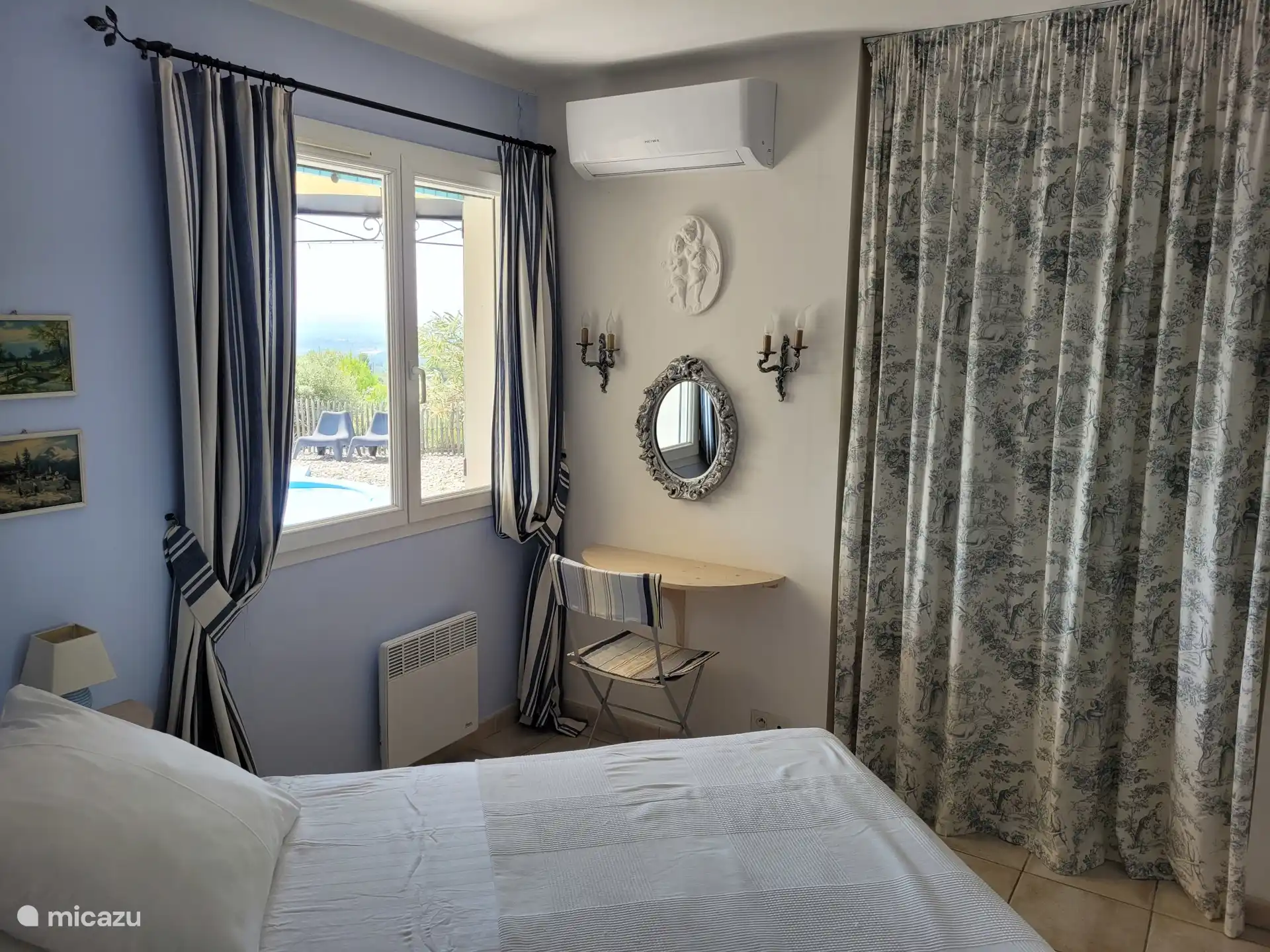 Bedroom with double bed and air conditioning. 