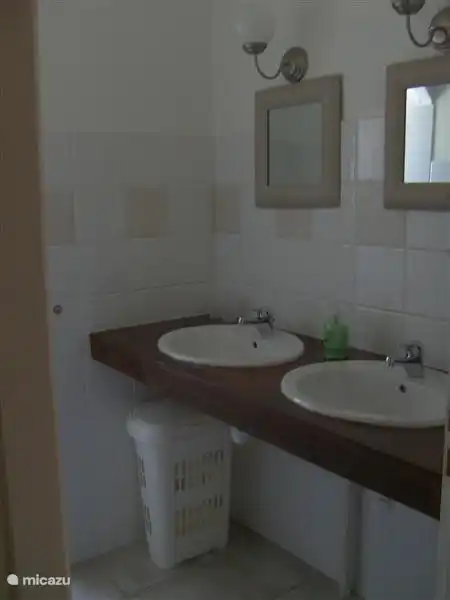 The second bathroom with double sinks and walk-in shower.
