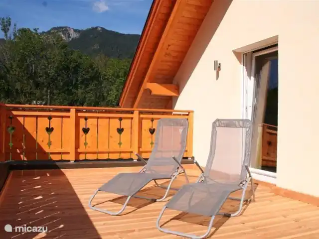 villa en Austria, Carintia, Kötschach-Mauthen – Villa Montañara Azotea espaciosa y soleada con tumbonas y vistas a la pista de esquí.