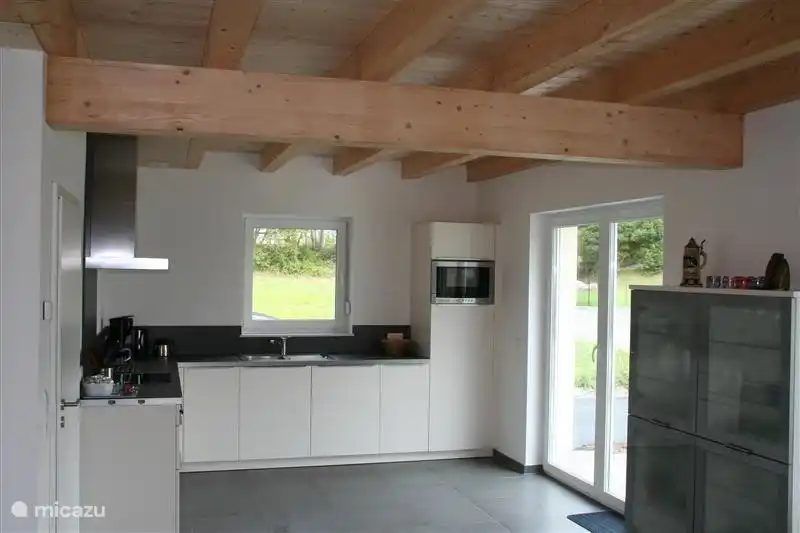 Cuisine de luxe ouverte avec portes-fenêtres donnant sur la terrasse