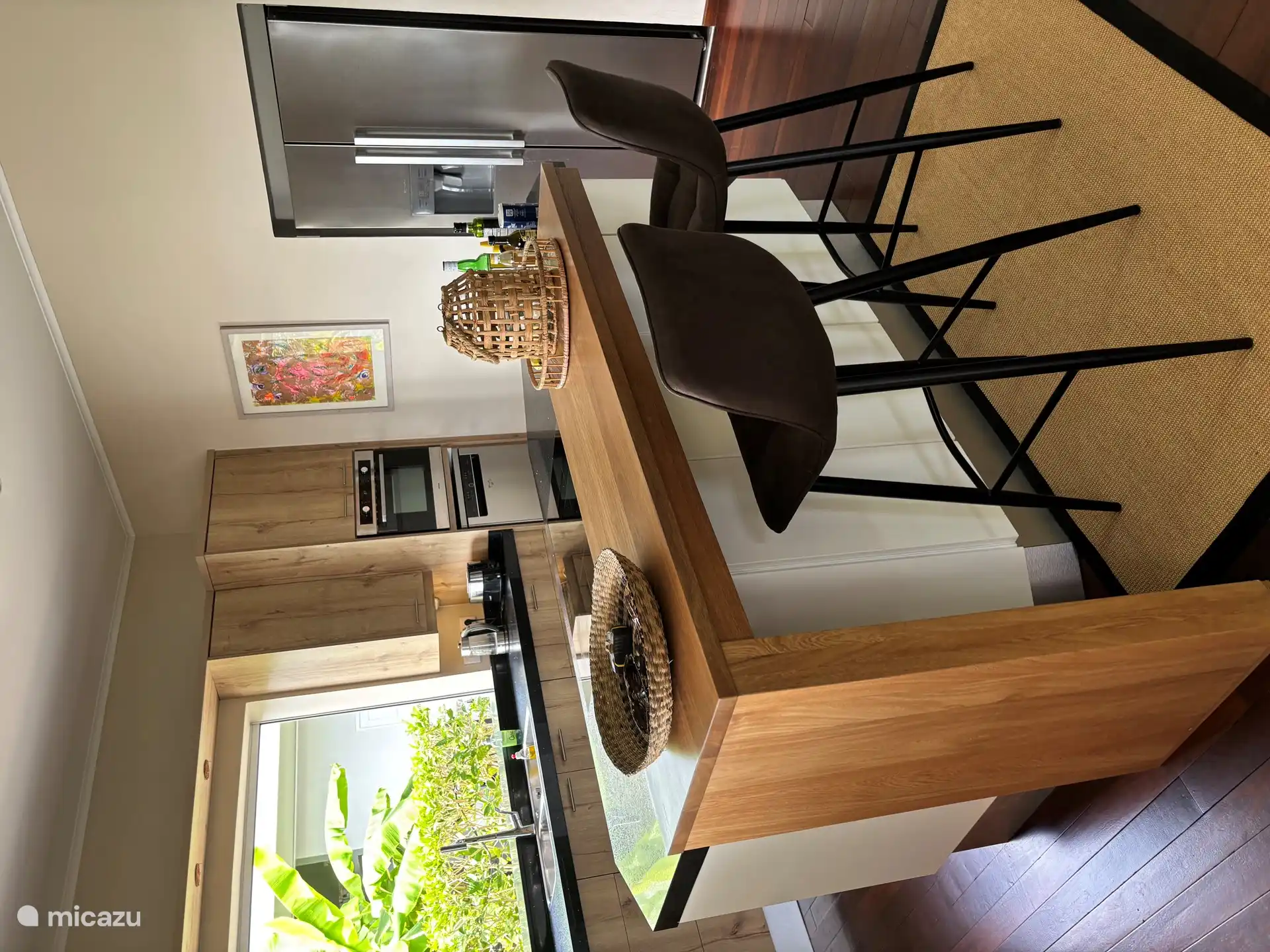 Modern open kitchen with a view of banana trees