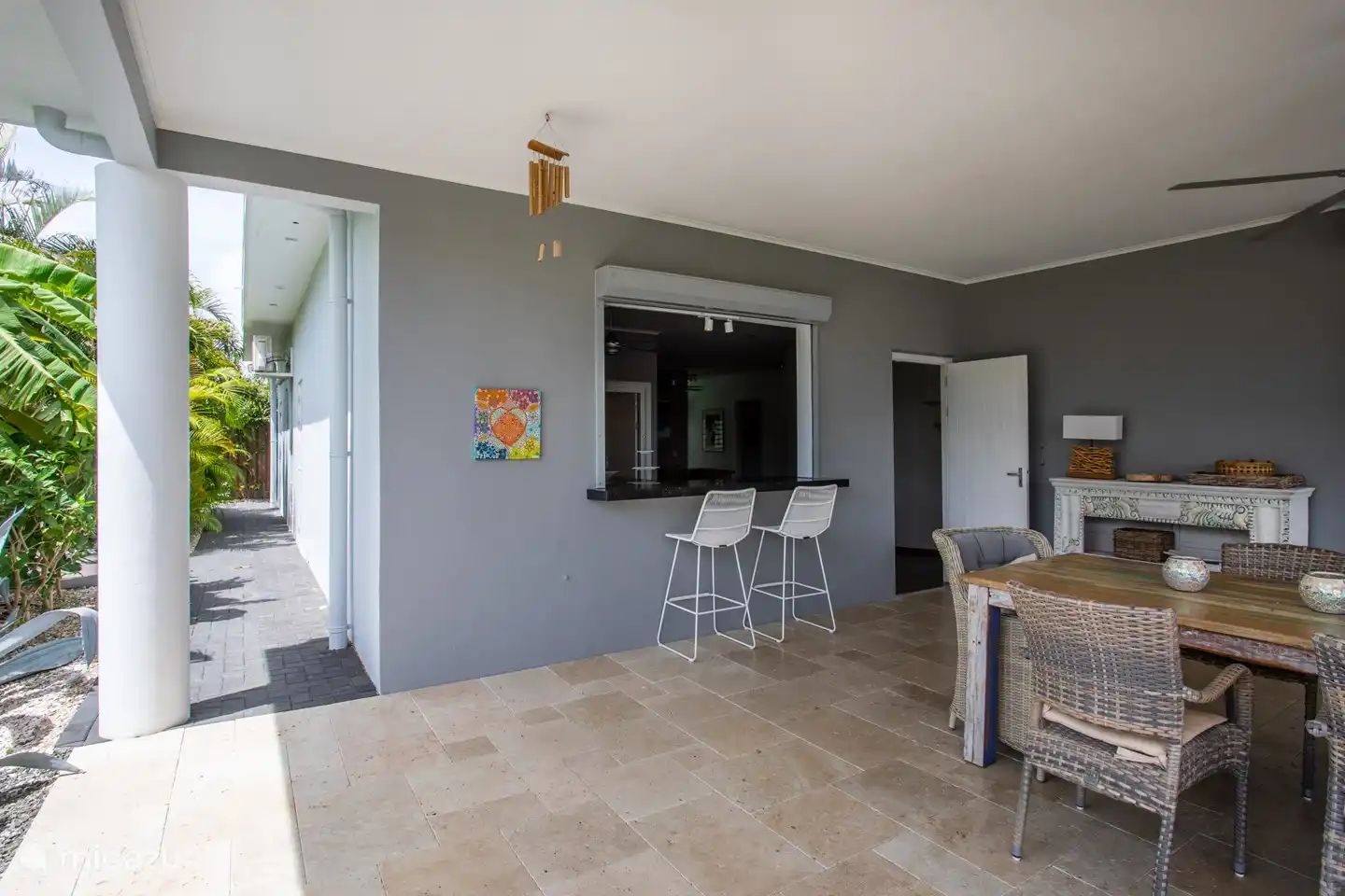 Patio with pass-through space and door to the kitchen
