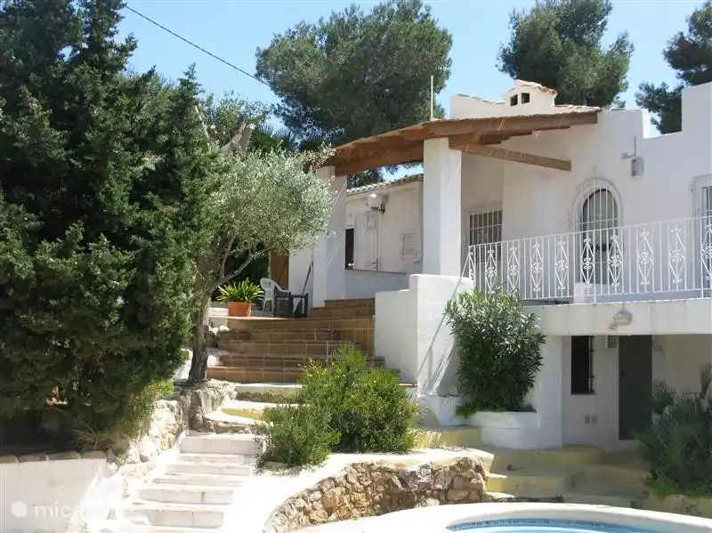 The villa, terraces and a garden full of trees and flowers