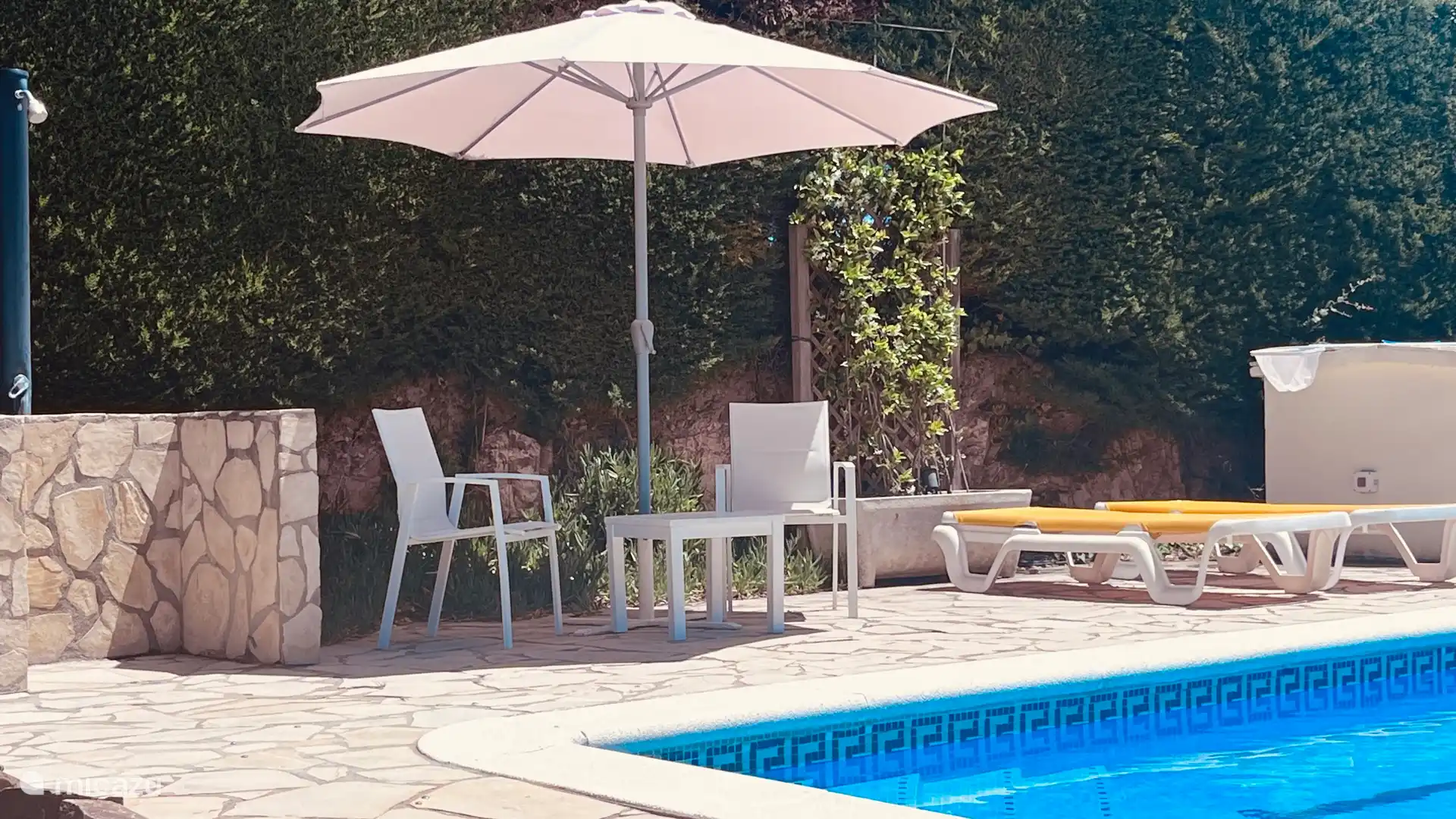 Lovely seat by the pool to catch those last rays of sunshine of the day.