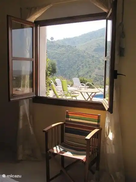 Spacious and bright bedroom overlooking the pool and terraces