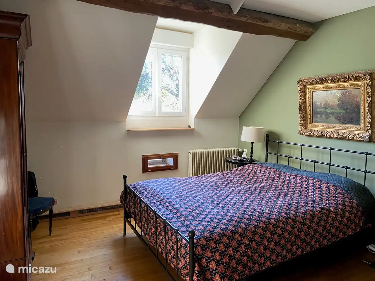 Bright master bedroom with antique wardrobe and double doors to the spacious landing with 2-person sofa bed.