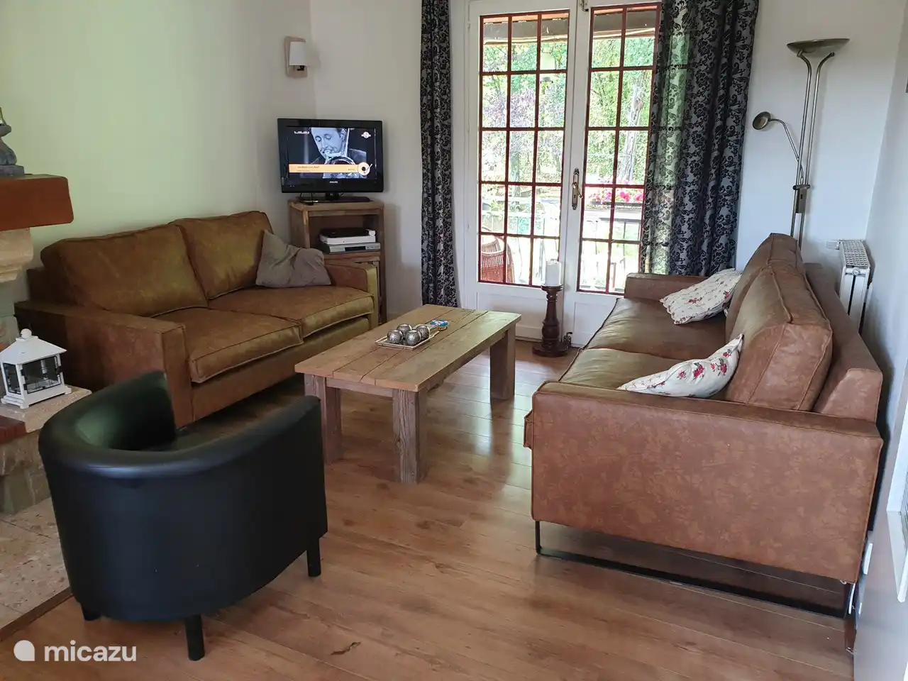 Salon avec beau canapé spacieux et TV avec chaînes néerlandaises