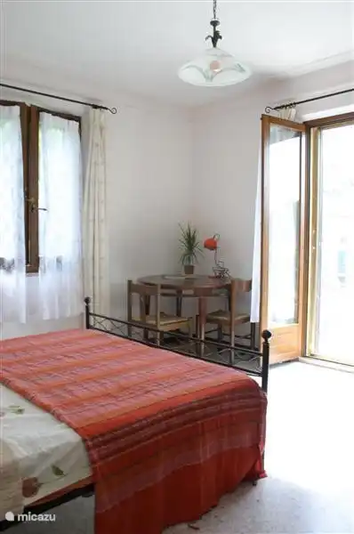 spacious bedroom with balcony doors