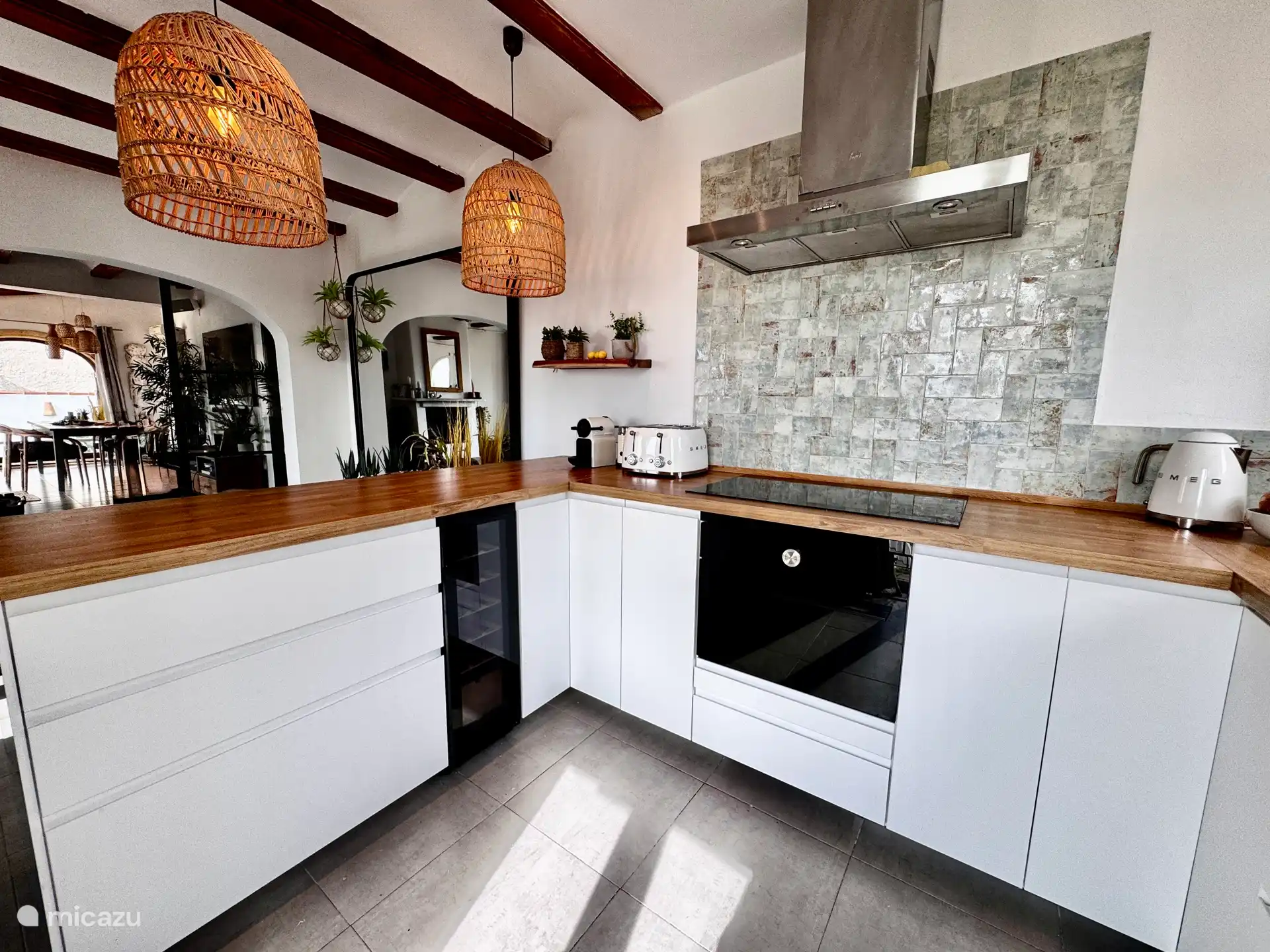 Kitchen on the upper floor with various appliances such as oven / microwave combi, refrigerator, electric hob, wine cabinet, Nespresso coffee machine.
