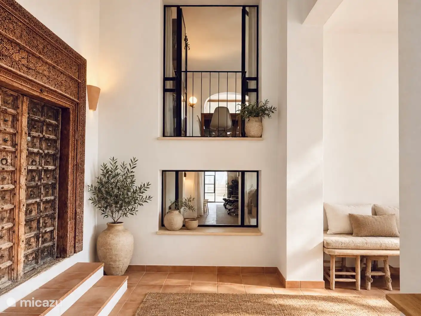 Portion of indoor kitchen overlooking downstairs apartment and fitness room