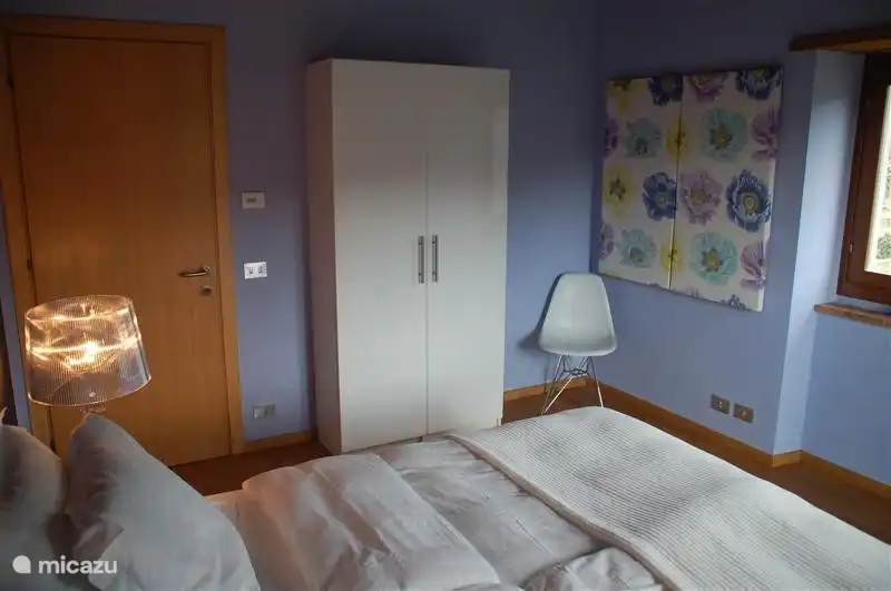 El dormitorio azul en el primer piso con una cama doble.