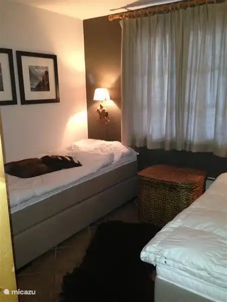 The bedroom on the ground floor with two separate box-spring beds