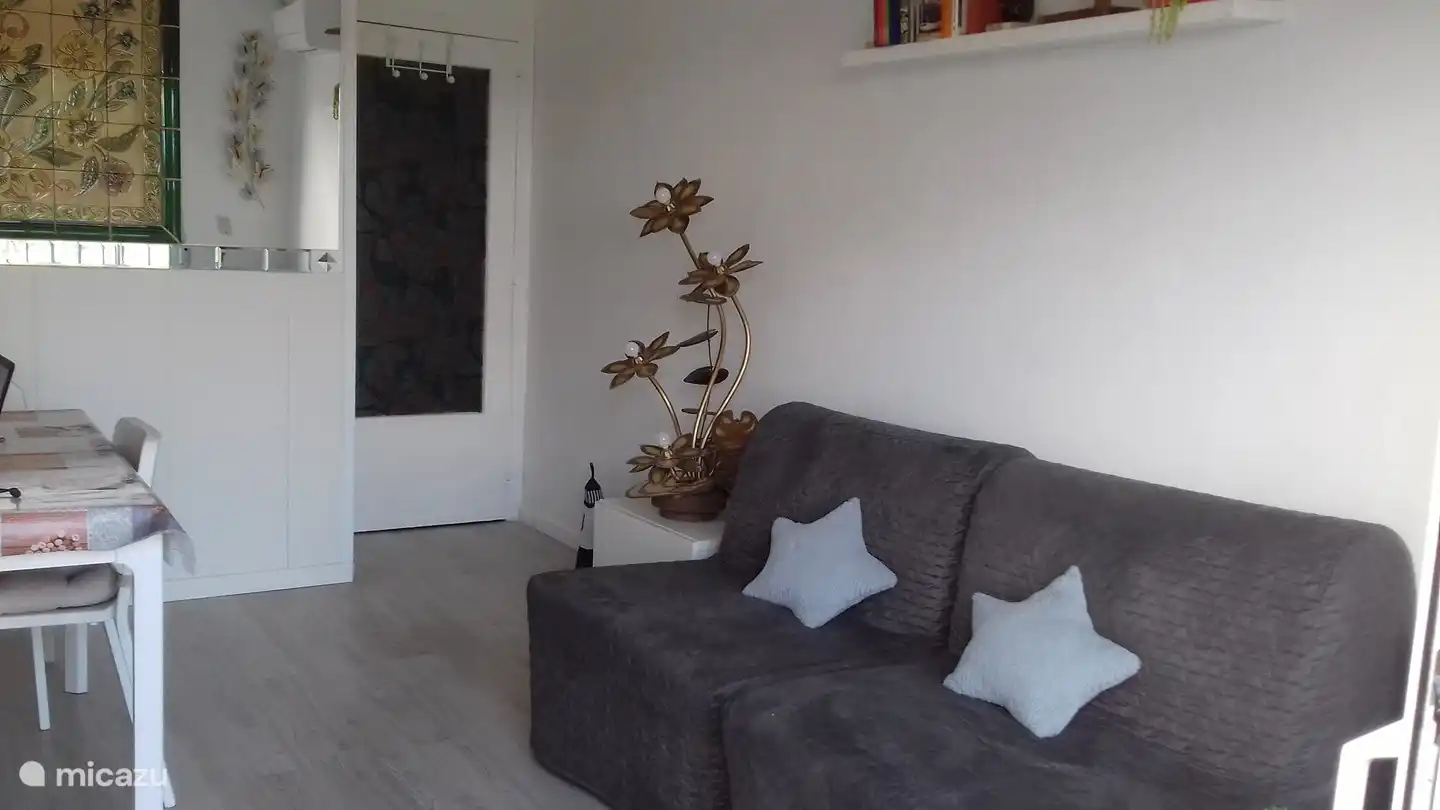 the living room that has been transformed into 2 beds