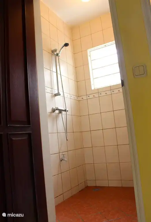 Spacious bathroom with hot water that you can easily set up as required by the thermostat.