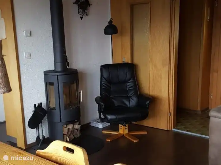 The wood stove and a lovely reading corner in the living room.