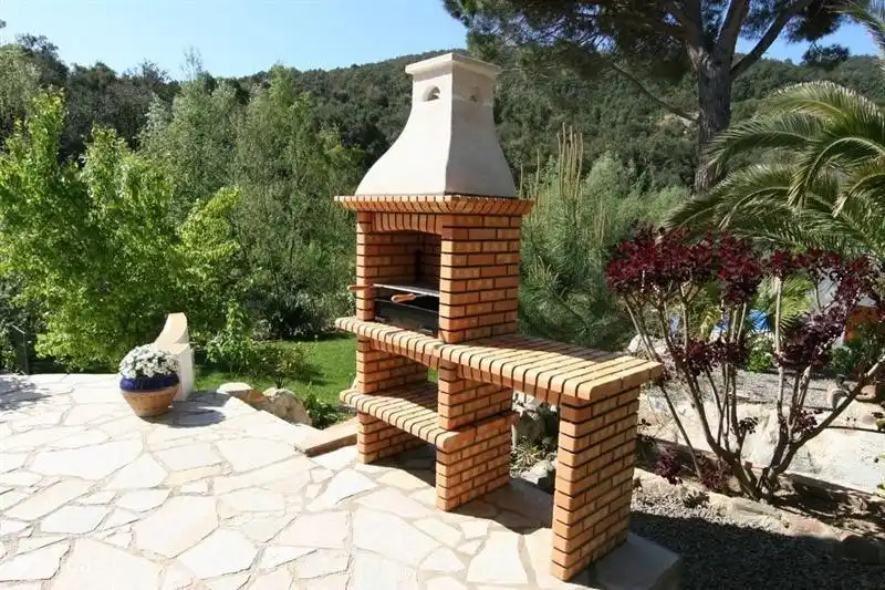 Fixed BBQ near the dining table outside.