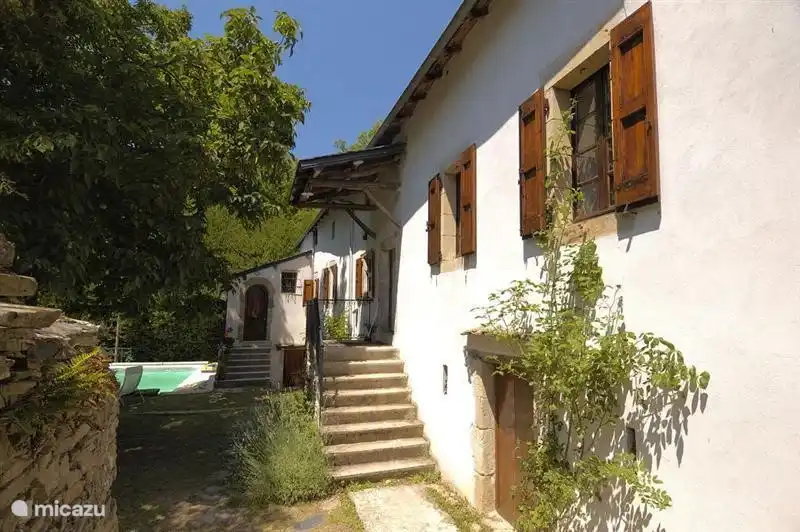 Vista a lo largo de la fachada suroeste y horno exterior a la piscina.