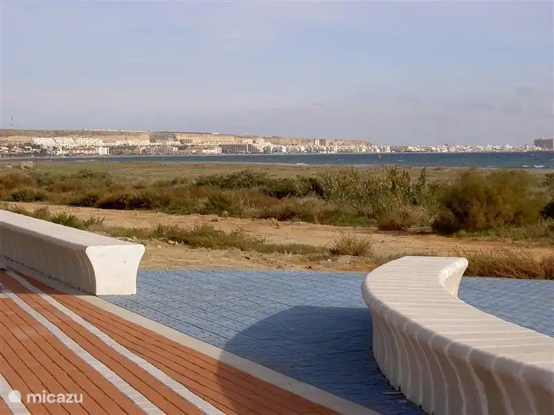 The boulevard of Almerimar with the distant buildings of Almerimar.