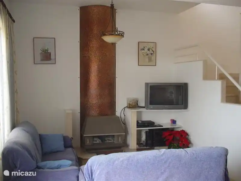 TV corner with Dutch channels via satellite (SAT1) and the stairs to the first floor.