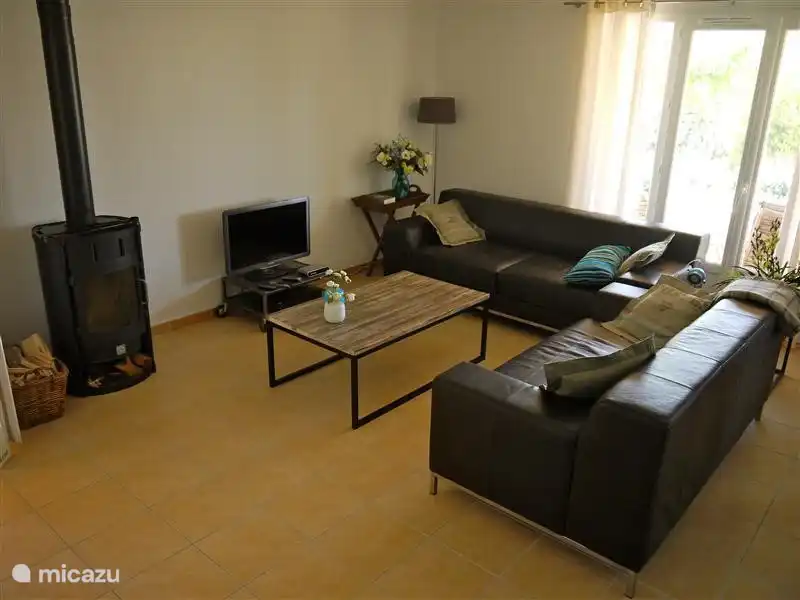 Spacious sitting area with 2 sofas, 2 armchairs, fireplace, TV with English channels, DVD player