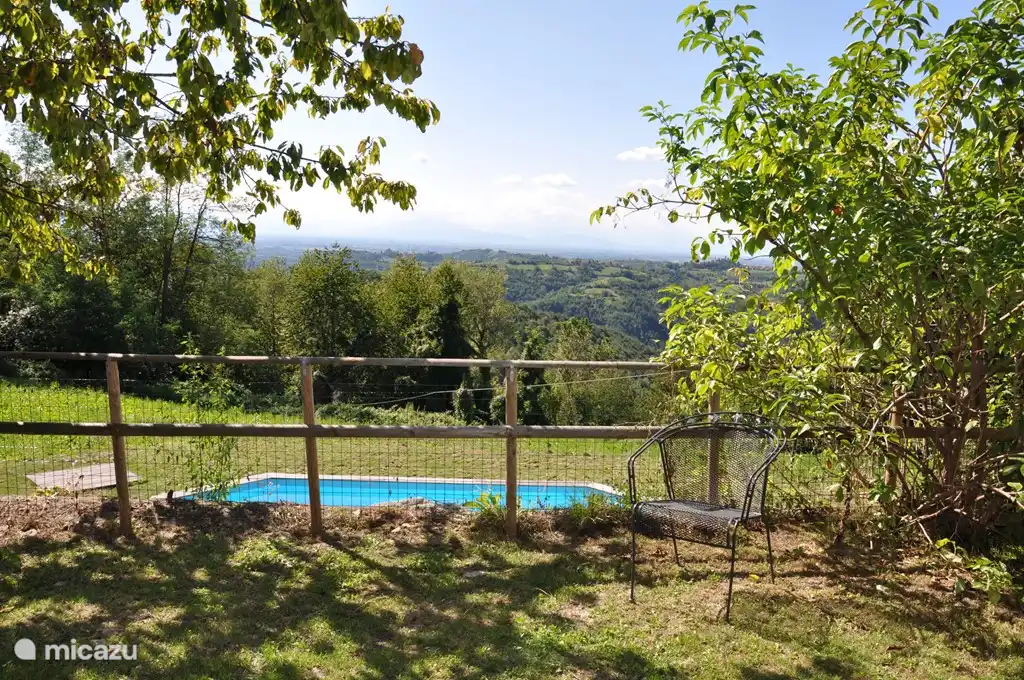 View from the garden to the pool, the village of Castellino Tanaro and in the background the French-Italian Alps.